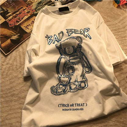 White long-sleeve shirt with 'Bad Bear' graphic design on a textured surface.