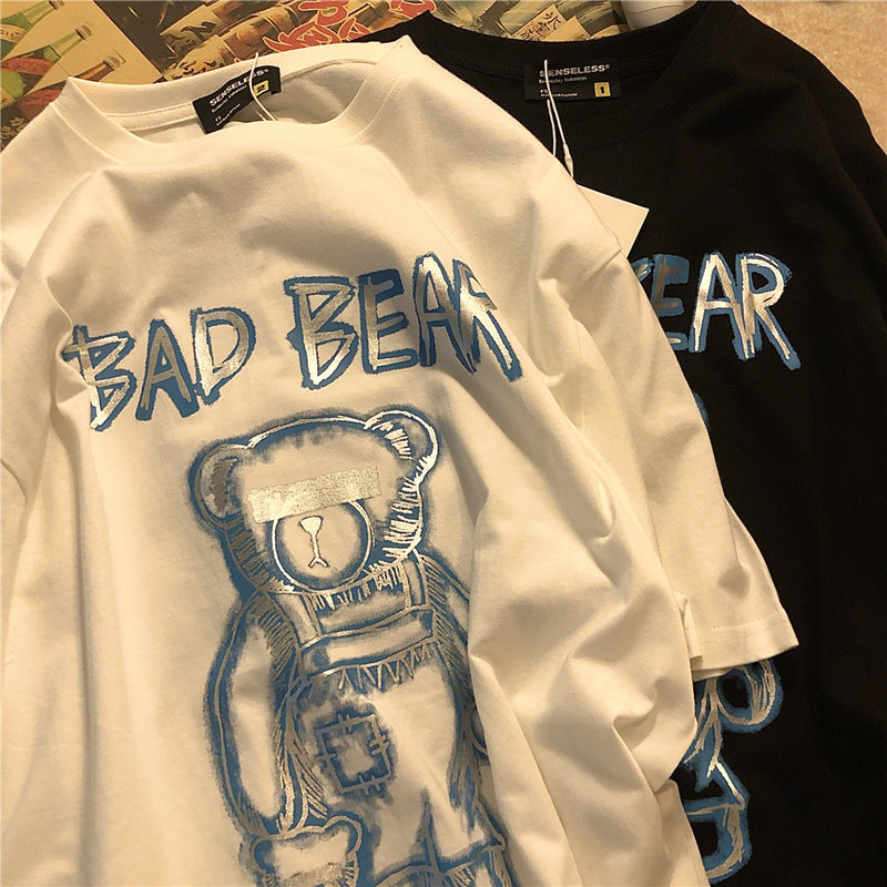 Two sweatshirts with 'BAD BEAR' text and bear graphic design on a textured surface.