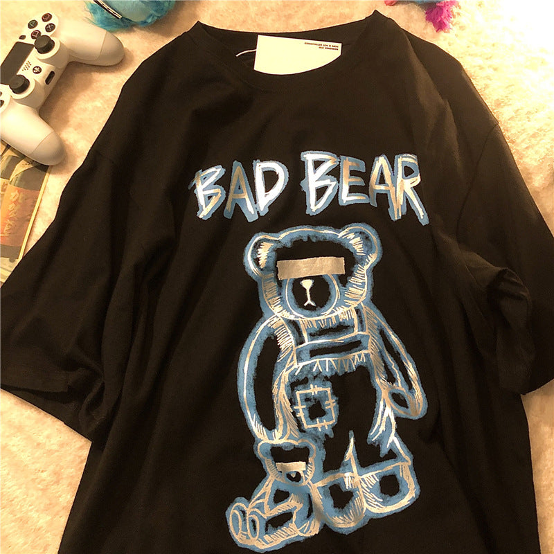Black t-shirt with 'BAD BEAR' graphic design on a textured surface.