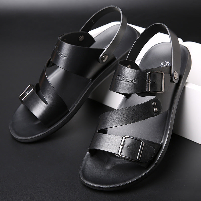 Black sandals with multiple straps on a dark background