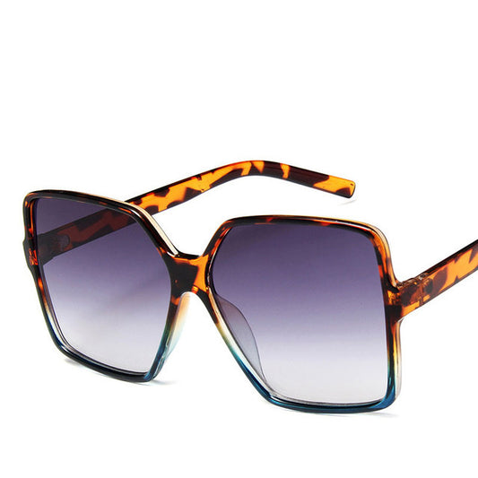 Sunglasses with tortoiseshell frame and gradient lenses on a white background