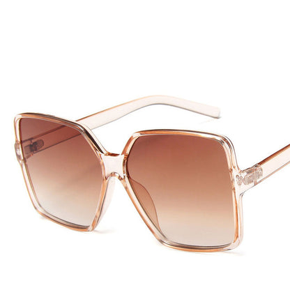 Sunglasses with a clear frame and brown gradient lenses on a white background