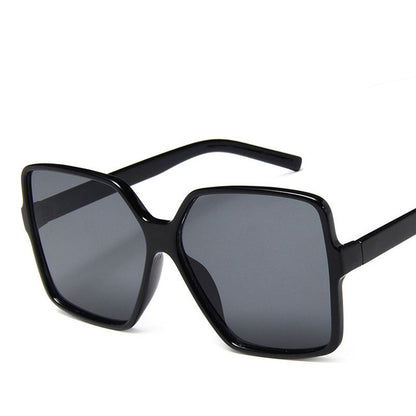 Black sunglasses with dark lenses on a white background