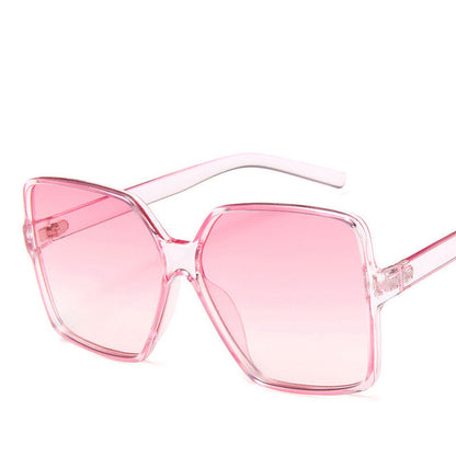 Pink sunglasses with a clear frame on a white background