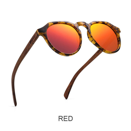 Sunglasses with tortoiseshell frame and red lenses on a white background