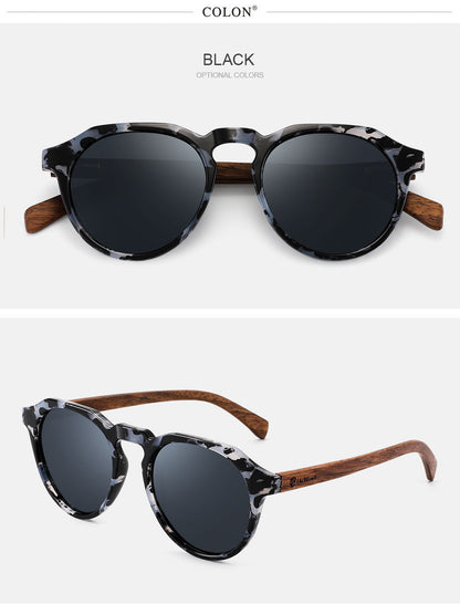 Round sunglasses with black lenses and wooden arms on a white background, featuring the brand 'Colon'.