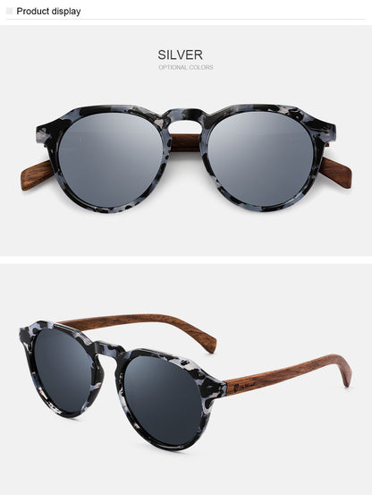 Sunglasses with a silver frame and wooden arms on a white background