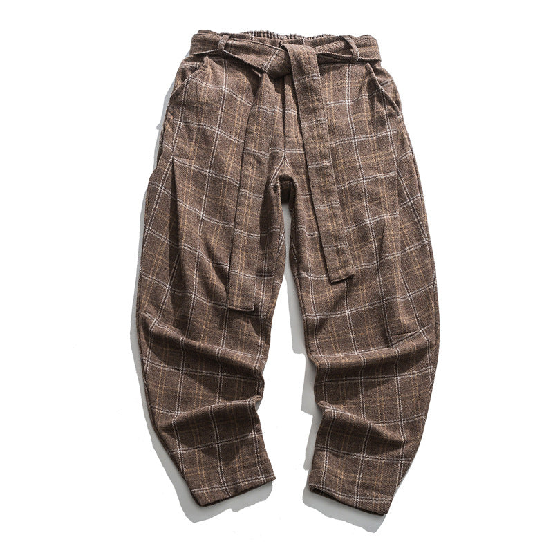 Brown plaid pants with a tie-waist design on a white background