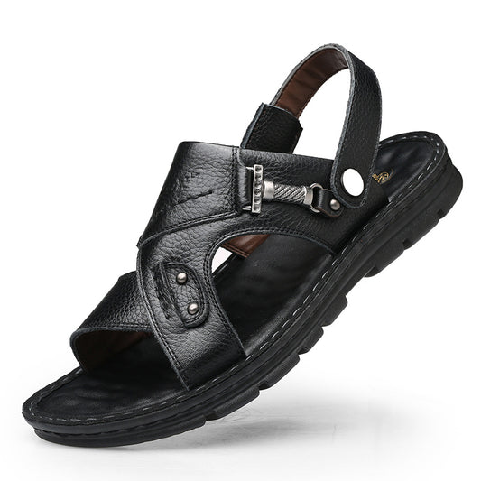 Black leather sandal with metallic buckle on a white background