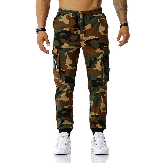 Camouflage pants worn by a person on a white background