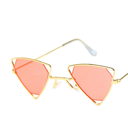 Gold-framed sunglasses with pink lenses on a white background
