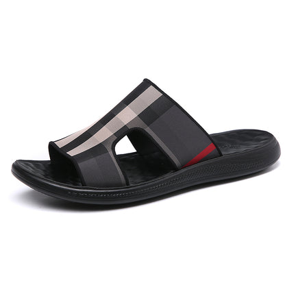 Black sandal with a striped design on a white background