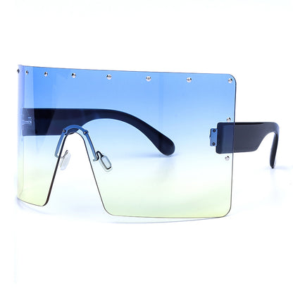 Sunglasses with gradient blue to green lens on a white background