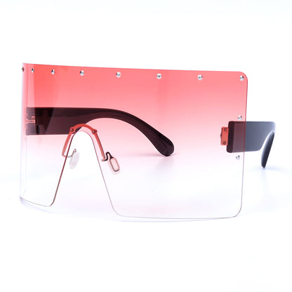 Sunglasses with a gradient pink to clear design on a white background