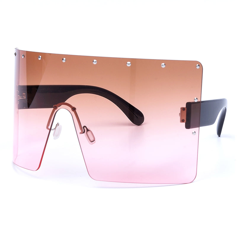 Sunglasses with a gradient pink to brown lens on a white background