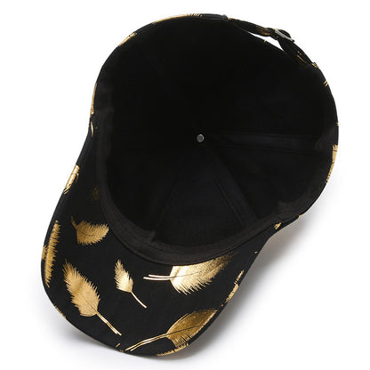 Black cap with gold feather patterns on a white background