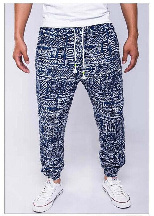 Blue patterned jogger pants worn by a person on a white background