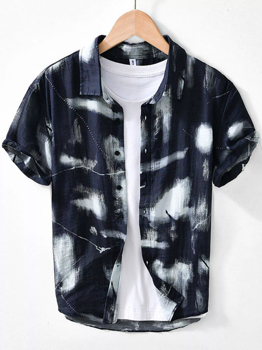 Black and white abstract patterned shirt on a hanger against a white background