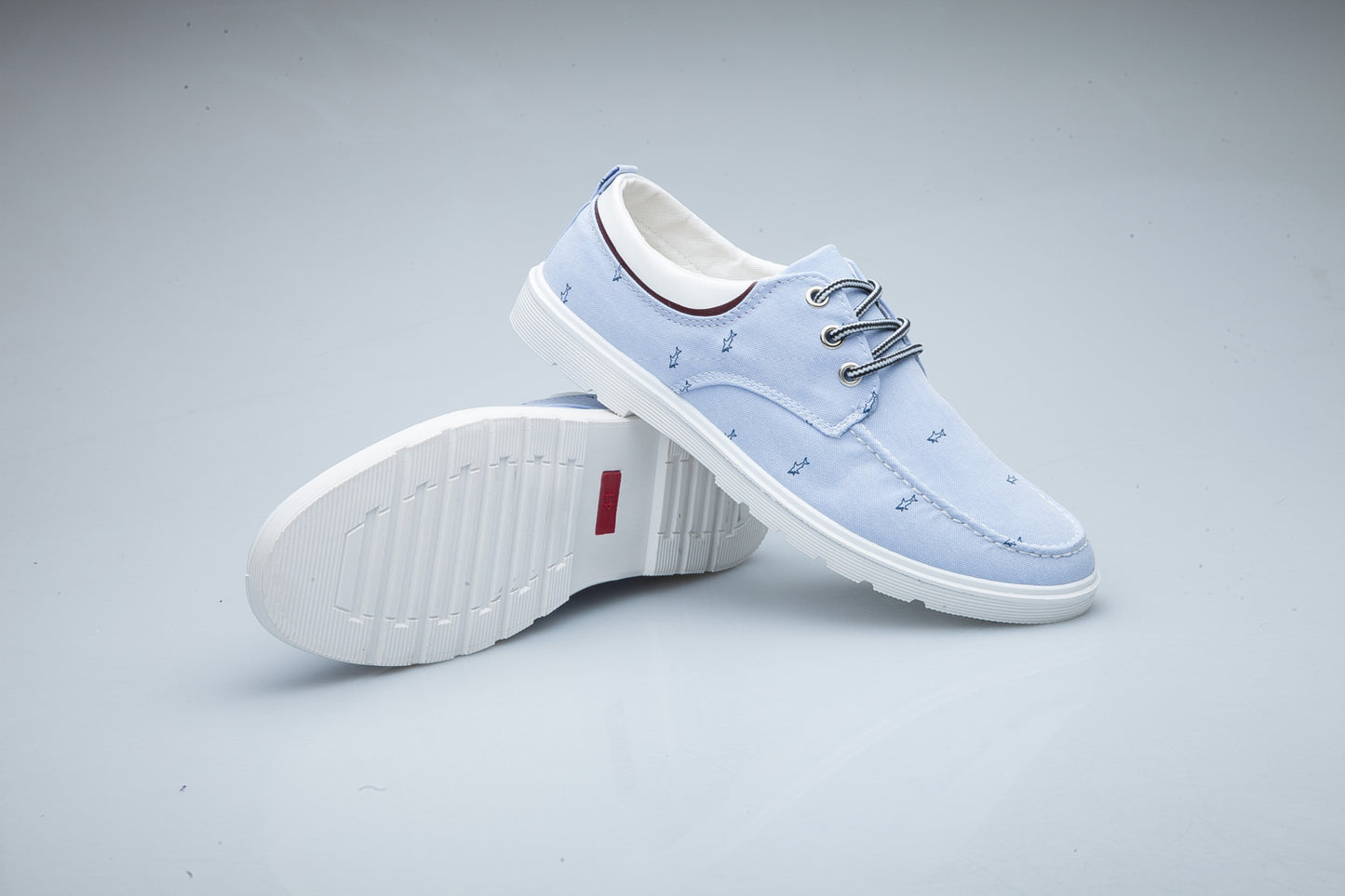 Light blue casual shoes on a gray background