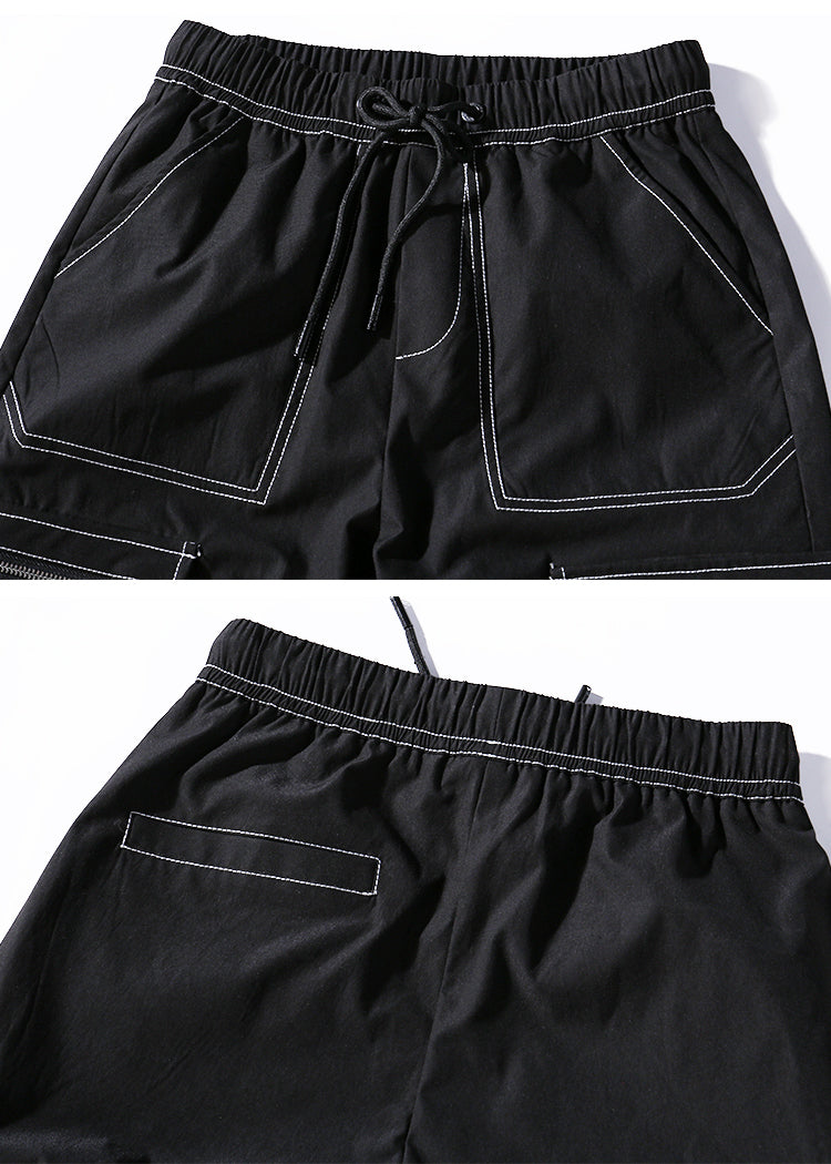 Black shorts with white stitching on a white background