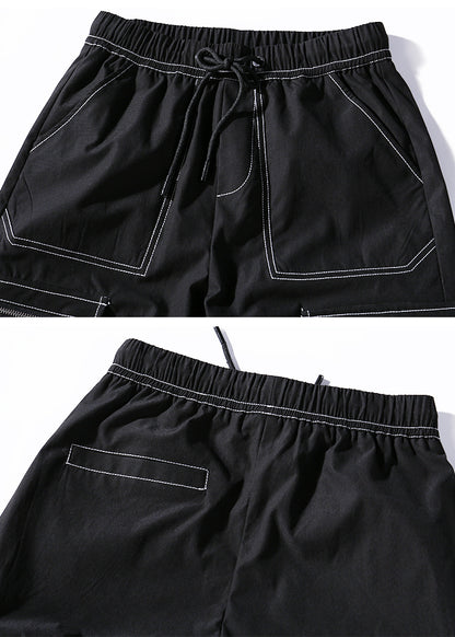 Black shorts with white stitching on a white background
