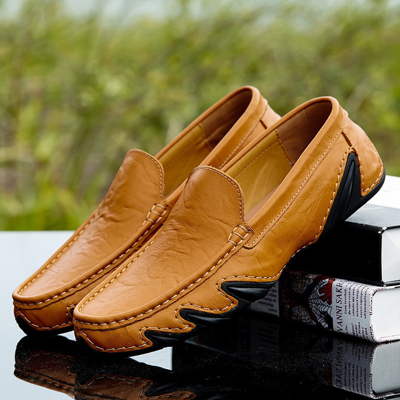 Brown loafers with a blurred green background