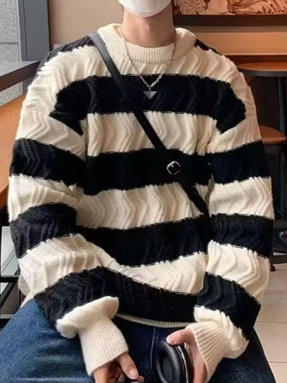 Person wearing a black and white striped sweater in an indoor setting