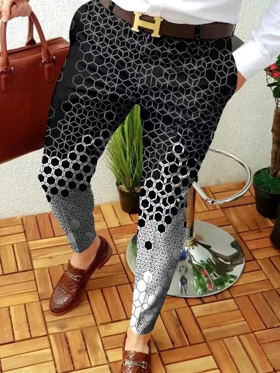 Person wearing black and white patterned pants on a wooden floor.