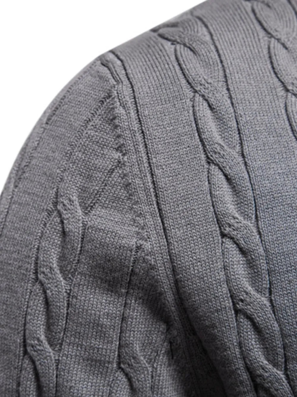 Close-up of a gray cable knit sweater sleeve