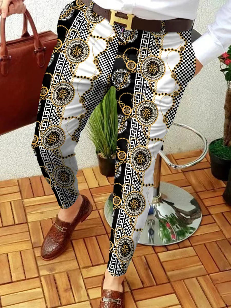 Person wearing patterned pants with a white shirt, brown shoes, and a brown handbag on a wooden floor.
