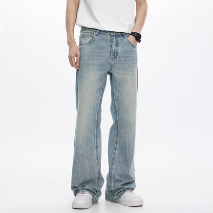 Person wearing light blue jeans and a white shirt on a white background