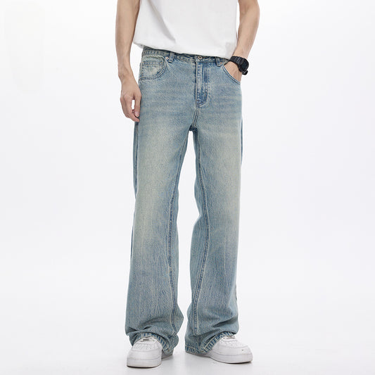 Person wearing light blue jeans and a white shirt on a white background