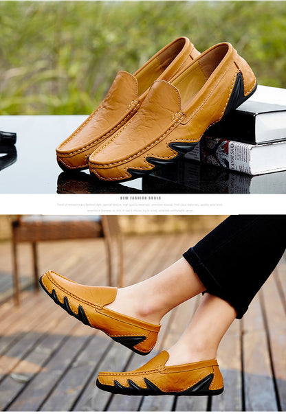 Yellow loafers with black accents on a reflective surface and being worn outdoors.