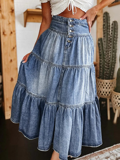 Denim skirt with layered design worn by a person indoors.