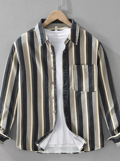 Striped shirt on a hanger against a gray background