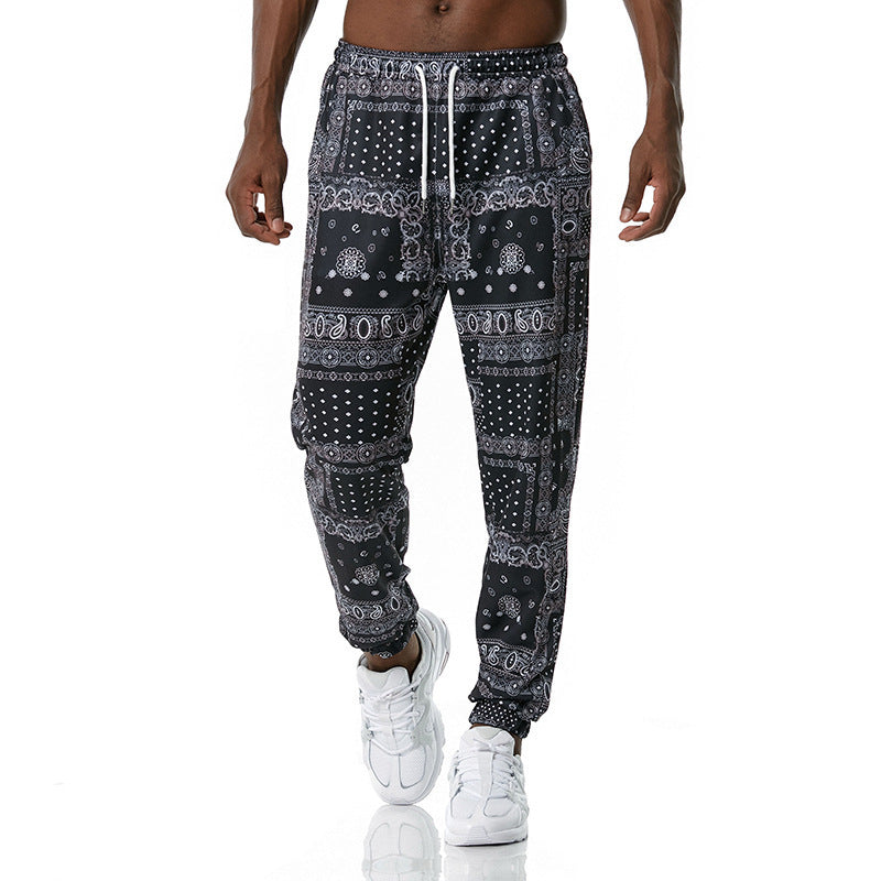 Black patterned jogger pants worn by a person on a white background