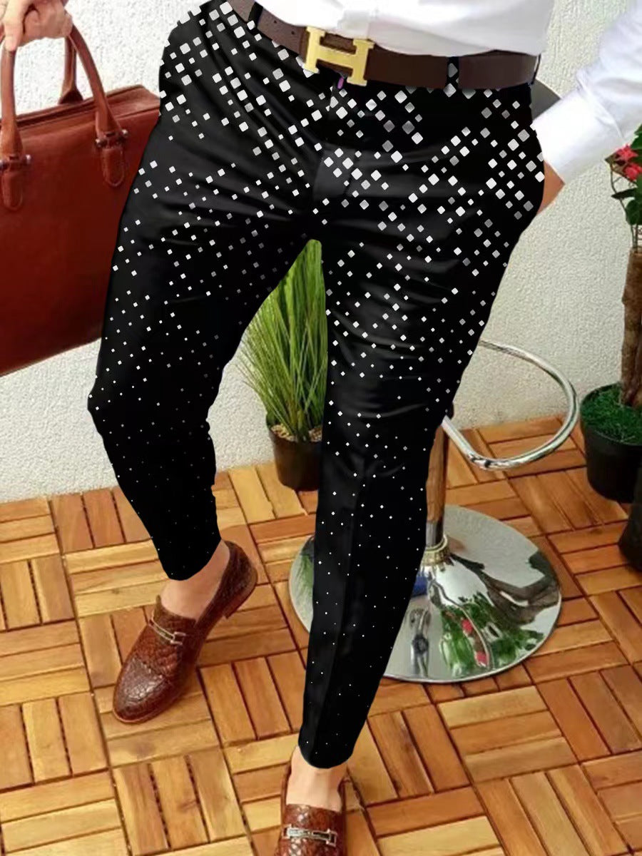 Person wearing black pants with white polka dots, standing on a wooden floor.