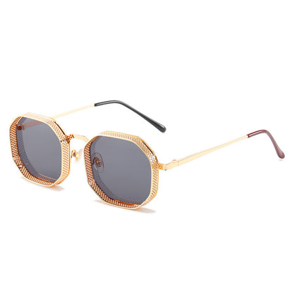 Gold-framed sunglasses with dark lenses on a white background