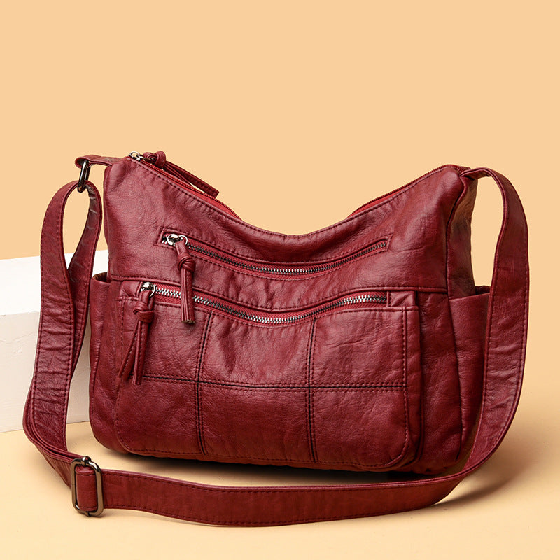 Red leather handbag on a beige background