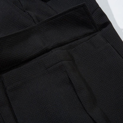 Close-up of black pants with a textured pattern