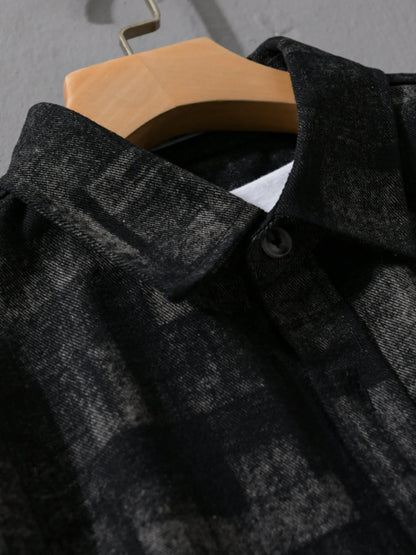 Black checkered shirt on a hanger against a gray background