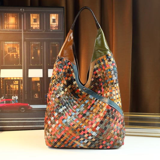 Multicolored woven handbag with a blurred cityscape background