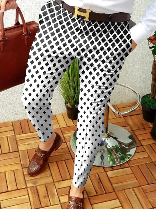 Person wearing black and white checkered pants with a brown belt, standing on a wooden floor.