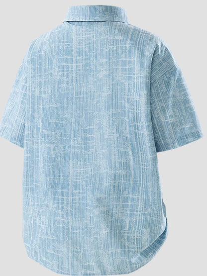Blue textured shirt on a light gray background