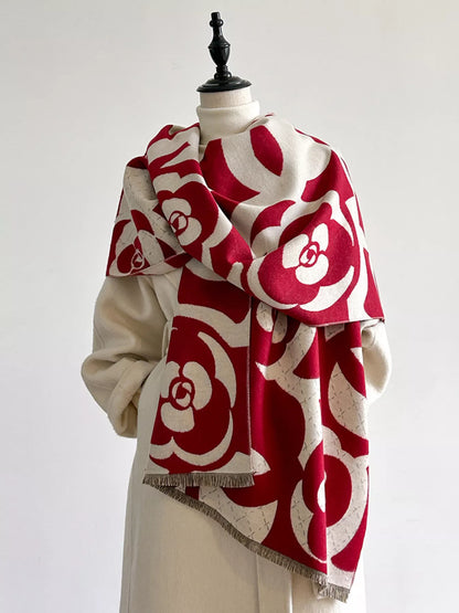 Red and white patterned scarf on a mannequin against a white background