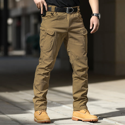 Person wearing tan cargo pants and boots on a blurred background