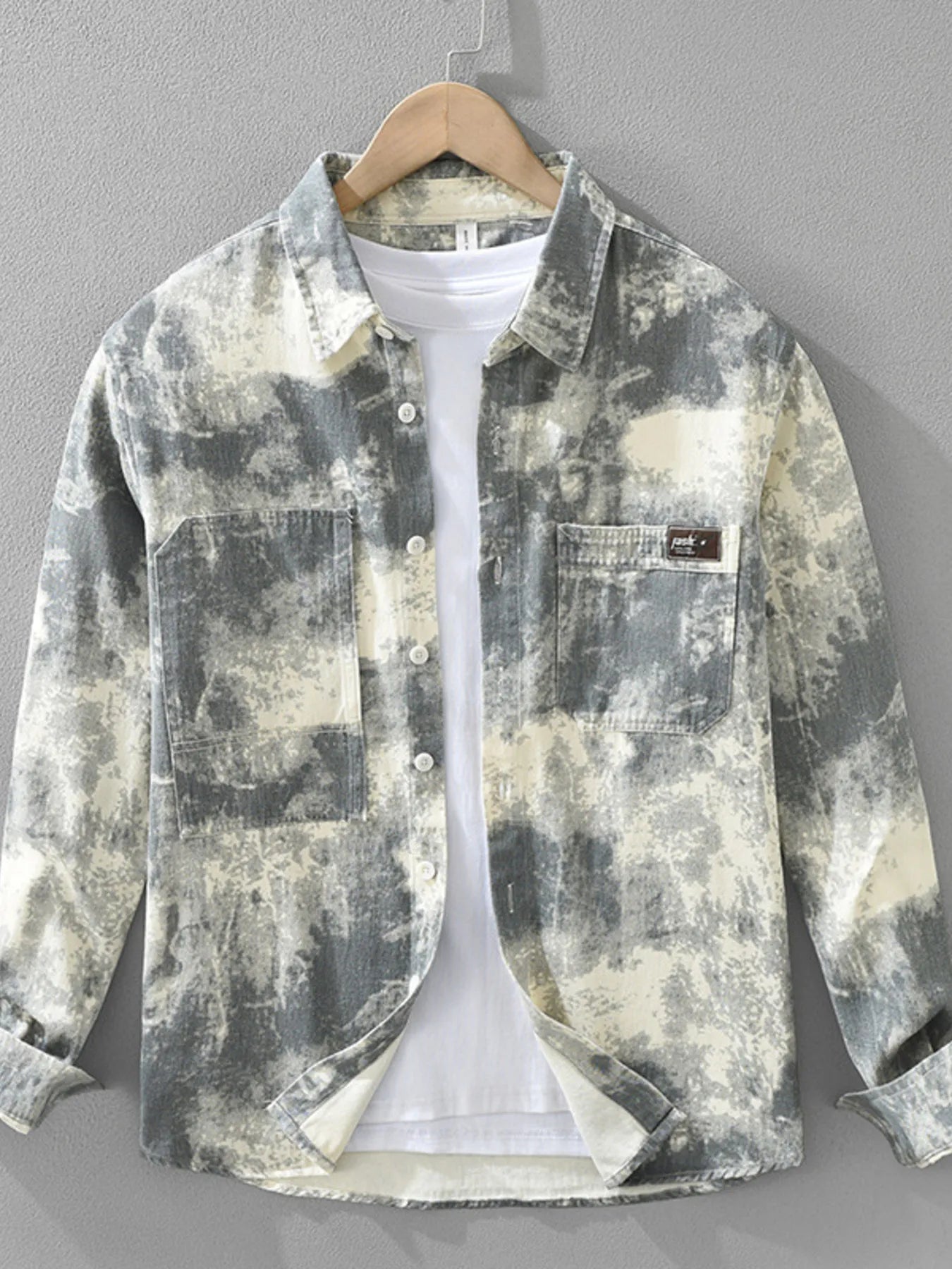 Abstract patterned shirt on a hanger with a gray background