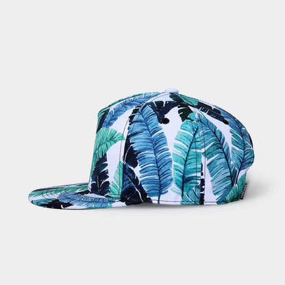 Cap with tropical leaf pattern on a light gray background
