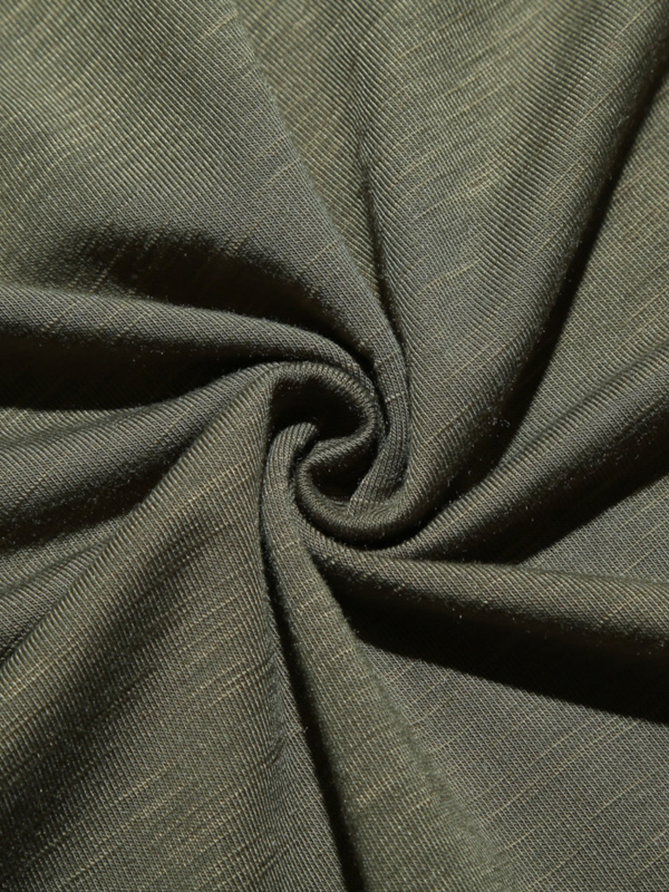 Close-up of olive green fabric with a subtle texture