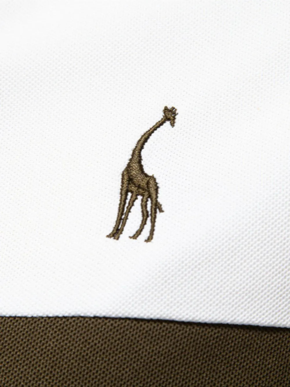 Embroidered giraffe design on a white fabric background